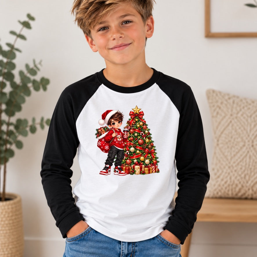 A young boy wearing a black and white raglan baseball t-shirt with a colorful Christmas graphic on the front, standing in a brightly lit indoor room.