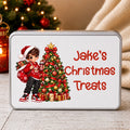 A rectangular tin of Christmas treats with a custom printed design. The design features an illustration of a young boy in a Santa hat next to a decorated Christmas tree, with the text 'Jake's Christmas Treats' in red.