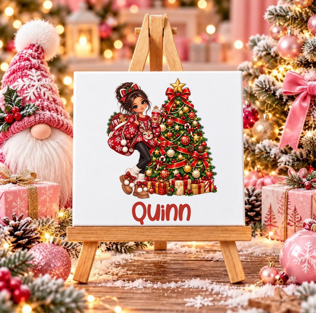 Personalised Christmas girl ceramic tile with name, featuring a festive girl beside a decorated Christmas tree, displayed on a wooden stand.
