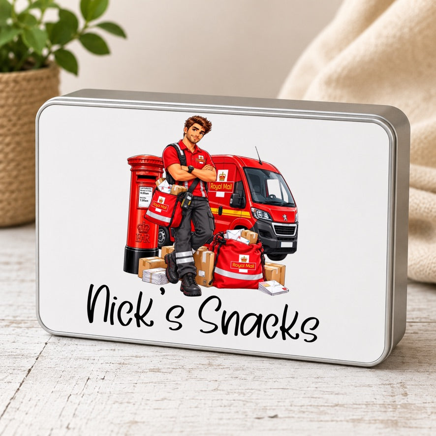 A rectangular metal tin with rounded corners and a silver-gray edge, featuring a printed illustration of a postman standing beside a red van and post box, with the text 'Nick's Snacks' below. The tin is photographed on a light wood surface with a soft neutral fabric and potted plant in the background.