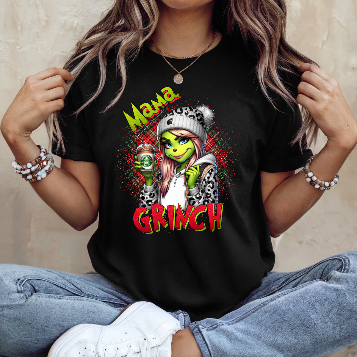 Shop our funny Mama Grinch Christmas T-shirt featuring a sassy green festive character with leopard print and coffee. A cute Christmas gift for Mum.